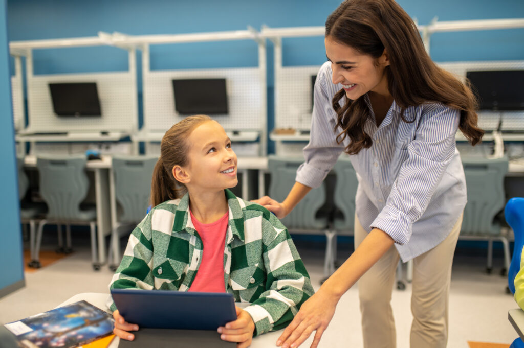 girl and teacher looking at each other