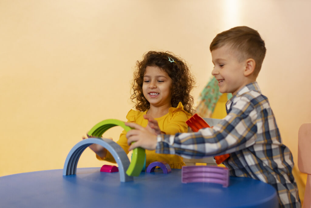 young boy girl playing indoors with eco toys