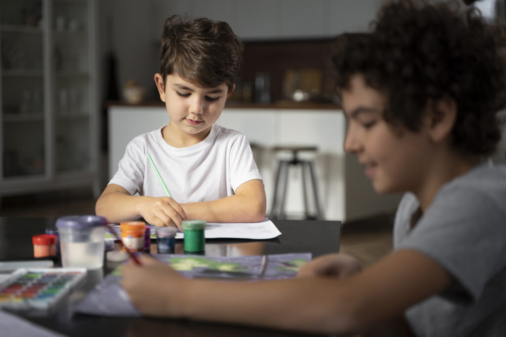 young kids painting with watercolor