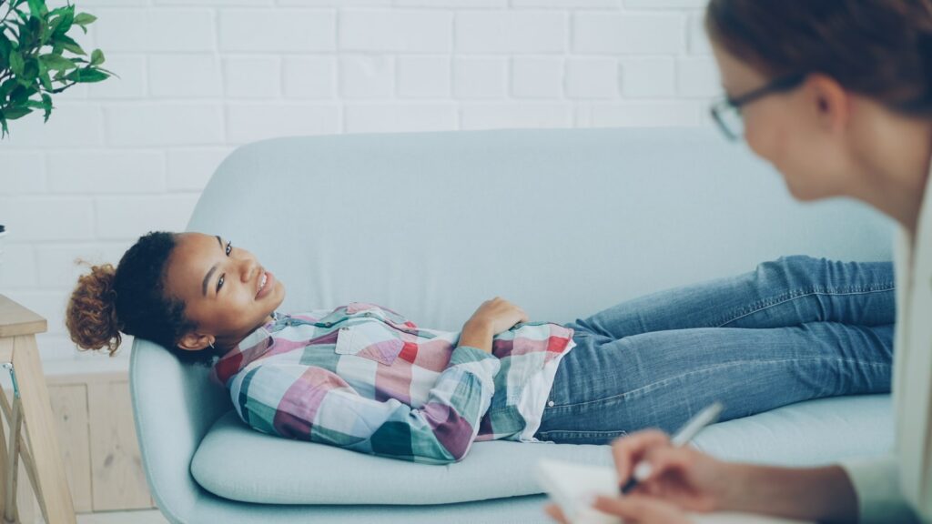 Child lying relaxed on a couch during a gentle hypnotherapy session for anxiety in children in Bangalore